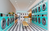 Moderne, kleurrijke wasserette met een vooraanzicht van rijen turquoise wasmachines, witte drogers en een retro zwart-wit geblokte vloer, inclusief houten bank en kledingrek op de achtergrond.