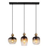 Hanglamp Trio Smoke Glas en Hout – Vooraanzicht van een moderne hanglamp met drie rookkleurige glazen kappen en houten accenten, bevestigd aan een zwarte plafondplaat met drie zwarte snoeren.