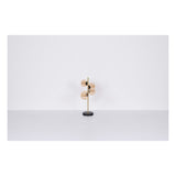 Moderne tafellamp met goudkleurige glazen bollen en messingkleurige staander op zwarte ronde voet, vooraanzicht tegen witte achtergrond.