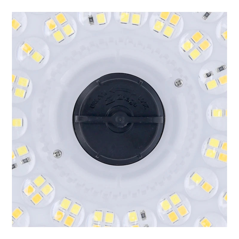Close-up van de onderzijde van een ronde LED-lamp met meerdere gele LED-chips rondom een zwarte centrale bevestigingsdop, zichtbaar in vooraanzicht.