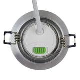 Bovenzicht van een ronde LED inbouwspot met instelbare kleurtemperatuur (WW, NW, CW) en zilverkleurige afwerking, inclusief montageveren en aansluitkabel.