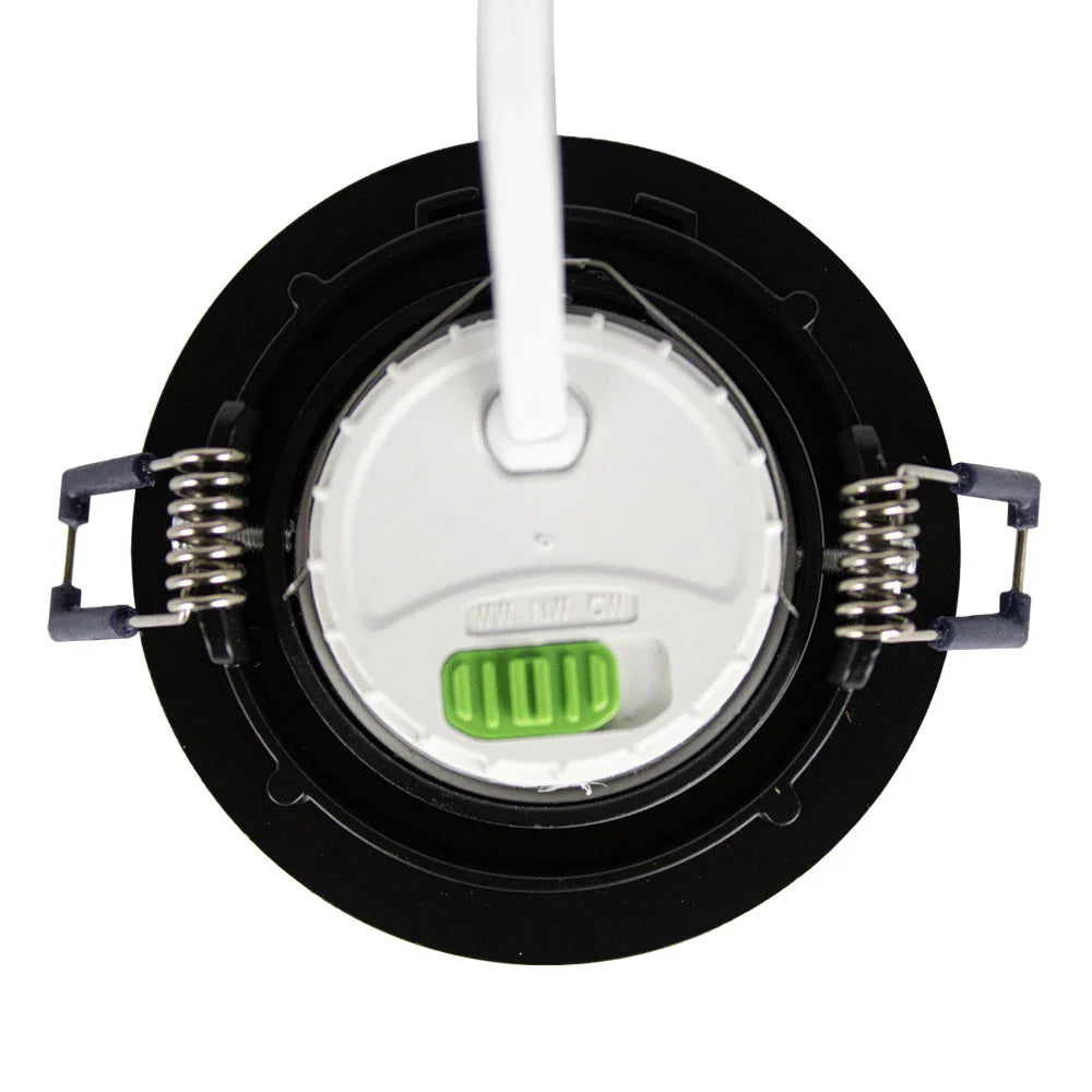 Bovenaanzicht van een zwarte LED inbouwspot met veerklemmen en witte aansluitkabel, inclusief groene schakelaar voor instelbare kleurtemperatuur.